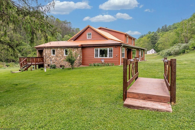 595 States Fork Rd, Metz, WV 26585 - back of house with a wooden deck, stone siding, a lawn, and a wooded view