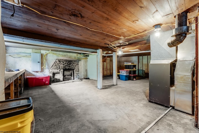 595 States Fork Rd, Metz, WV 26585 - unfinished basement with electric panel, heating unit, a fireplace, and wood ceiling