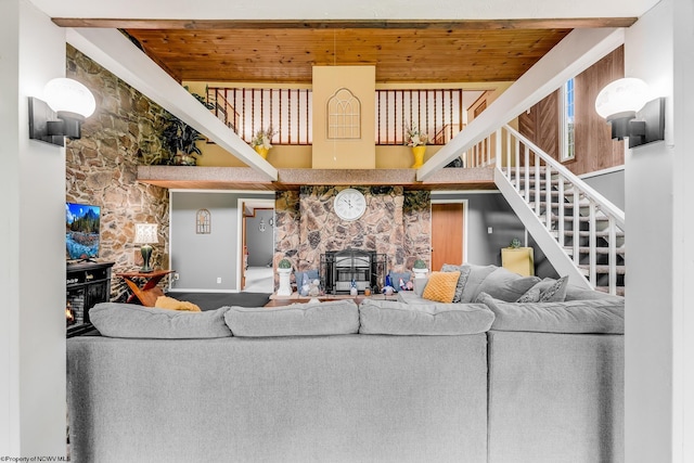 595 States Fork Rd, Metz, WV 26585 - living area with a wood stove, wood ceiling, stairway, and a towering ceiling