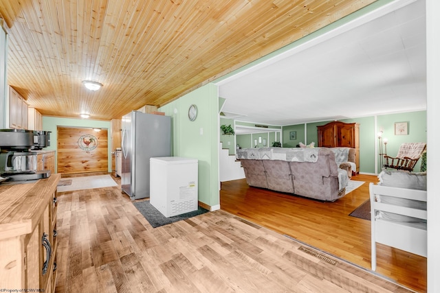595 States Fork Rd, Metz, WV 26585 - kitchen featuring freestanding refrigerator, light wood finished floors, and light countertops