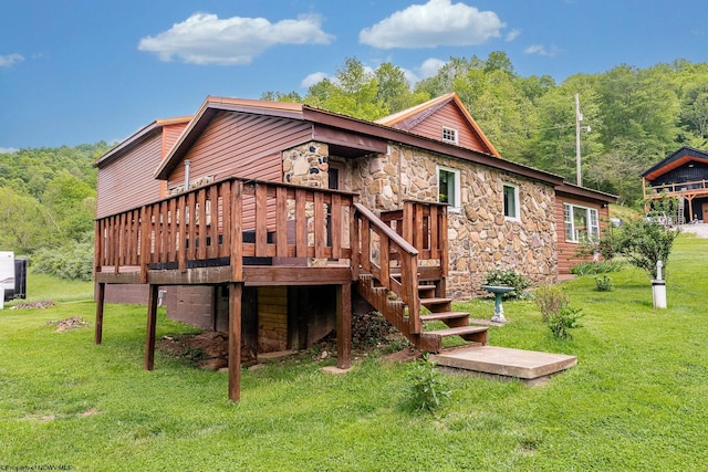 595 States Fork Rd, Metz, WV 26585 - rear view of property with stone siding, a yard, a deck, and a wooded view