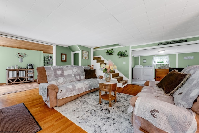 595 States Fork Rd, Metz, WV 26585 - living room with washing machine and dryer, wood finished floors, and stairway