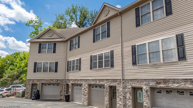 10 Pineview Pl, Morgantown, WV 26505 - view of side of property featuring an attached garage, stone siding, and driveway