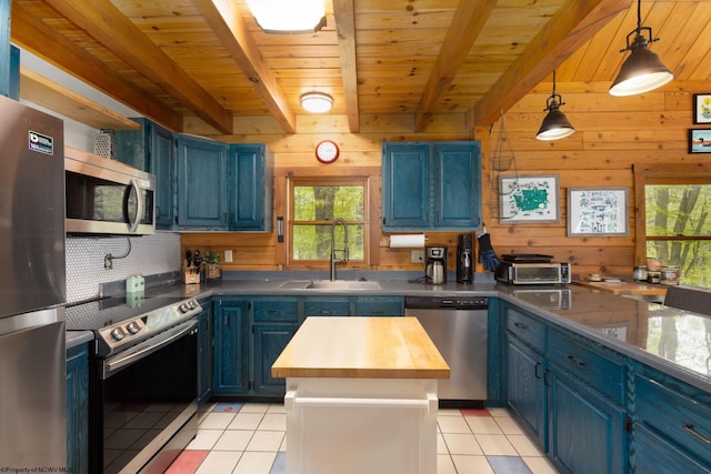 1 Ginger Ct, Terra Alta, WV 26764 - kitchen with blue cabinetry, stainless steel appliances, light tile patterned floors, a sink, and wood walls