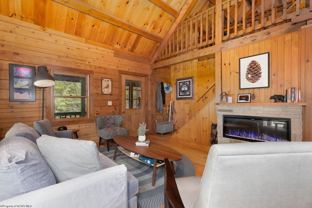 1 Ginger Ct, Terra Alta, WV 26764 - living room featuring a glass covered fireplace, wood walls, wood ceiling with exposed beams, and high vaulted ceiling