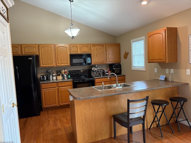 501 Santa Fe Ct, Morgantown, WV 26508 - kitchen featuring black appliances, a sink, a peninsula, vaulted ceiling, and light wood-type flooring