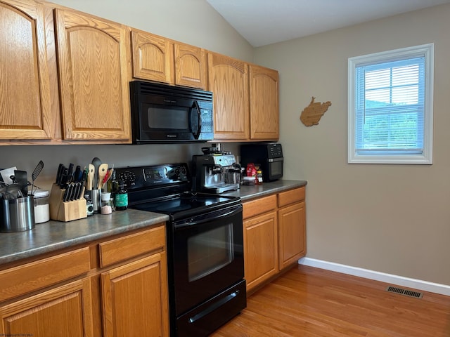 501 Santa Fe Ct, Morgantown, WV 26508 - kitchen featuring black appliances, dark countertops, light wood-style floors, baseboards, and lofted ceiling