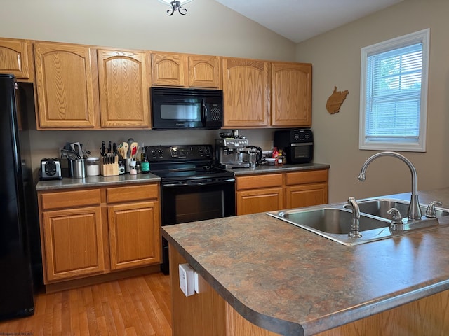 501 Santa Fe Ct, Morgantown, WV 26508 - kitchen featuring black appliances, a sink, vaulted ceiling, dark countertops, and light wood-style floors