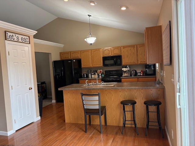 501 Santa Fe Ct, Morgantown, WV 26508 - kitchen featuring black appliances, a sink, a peninsula, decorative light fixtures, and a kitchen breakfast bar