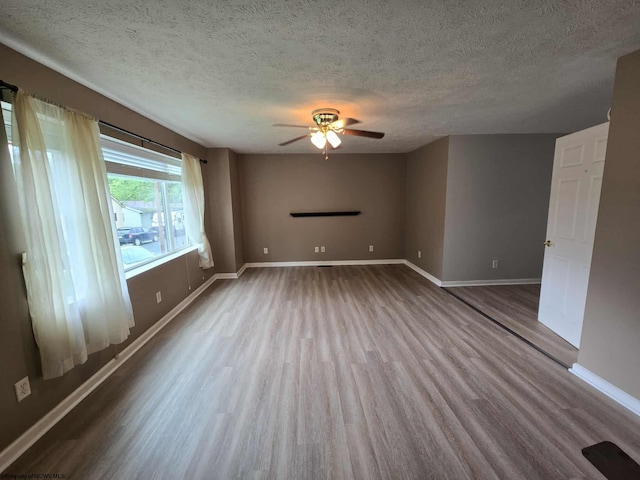 608 Ohio Ave, Nutter Fort, WV 26301 - unfurnished room with wood finished floors, a ceiling fan, a textured ceiling, and baseboards