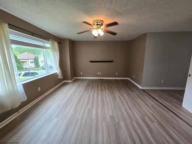 608 Ohio Ave, Nutter Fort, WV 26301 - unfurnished room with wood finished floors, a textured ceiling, ceiling fan, and baseboards