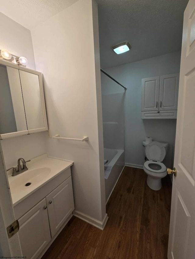 608 Ohio Ave, Nutter Fort, WV 26301 - full bathroom featuring wood finished floors, vanity, toilet, shower / bathtub combination, and a textured ceiling
