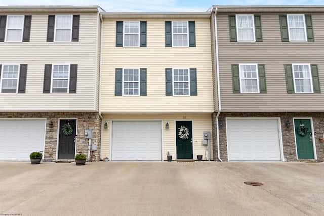 112 Eagle Dr, Maidsville, WV 26541 - townhome / multi-family property featuring a garage, driveway, and stone siding