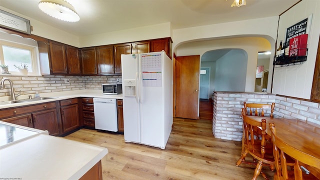 1601 Green Gables Rd, Fairmont, WV 26554 - kitchen featuring white appliances, a sink, arched walkways, light wood finished floors, and light countertops