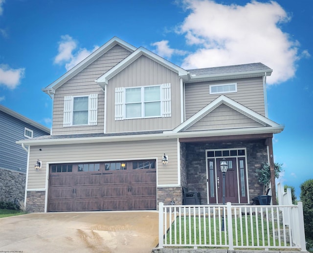 123 Sadie Ln, Morgantown, WV 26508 - view of front of property featuring stone siding, a fenced front yard, an attached garage, concrete driveway, and a porch