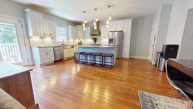 123 Sadie Ln, Morgantown, WV 26508 - kitchen with stainless steel appliances, custom exhaust hood, healthy amount of natural light, white cabinetry, and recessed lighting