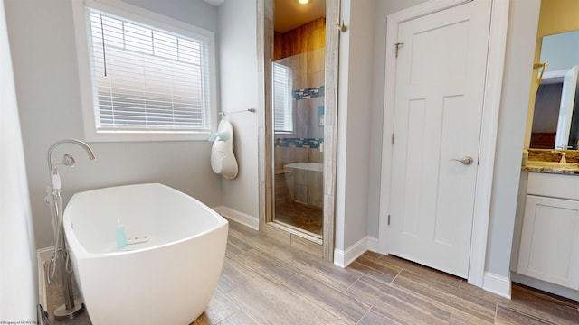 123 Sadie Ln, Morgantown, WV 26508 - bathroom featuring a stall shower, vanity, a freestanding bath, and wood finished floors
