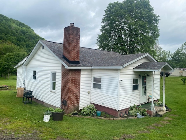 21434 Seneca Trl, Valley Head, WV 26294 - back of house featuring roof with shingles, a lawn, and a chimney