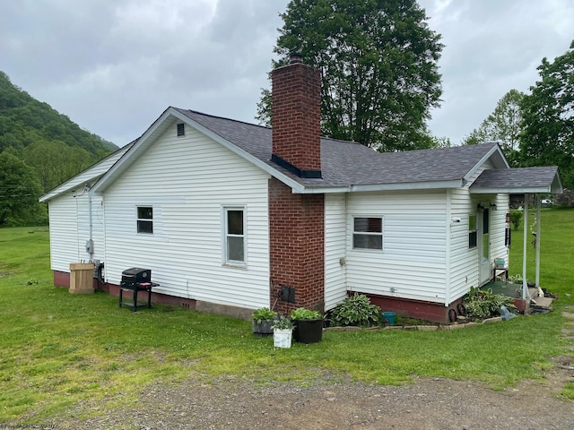 21434 Seneca Trl, Valley Head, WV 26294 - back of property with a chimney, a yard, and roof with shingles