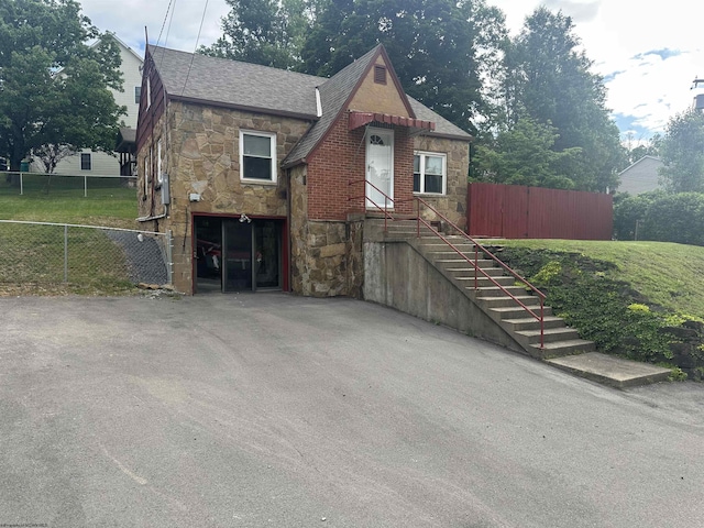 2605 E Main St, Bridgeport, WV 26330 - tudor-style house with stone siding and roof with shingles