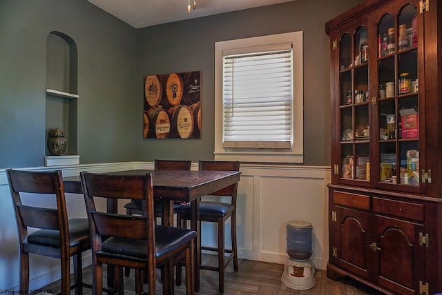 1917 Pleasant Valley Rd, Fairmont, WV 26554 - dining area with wainscoting, a decorative wall, and dark wood-style flooring