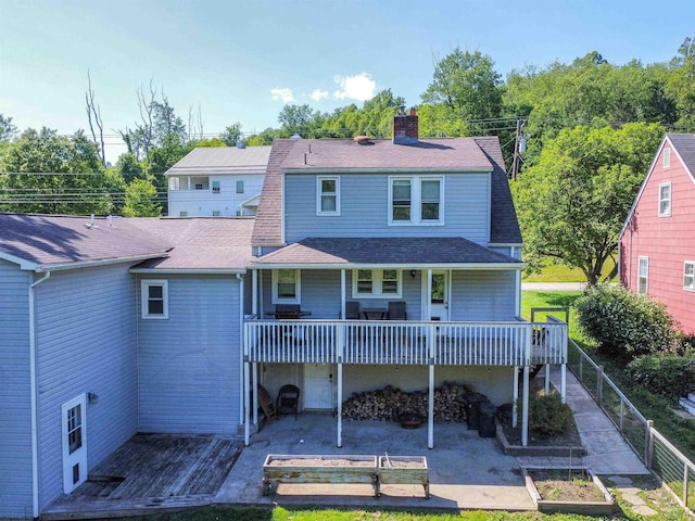 1917 Pleasant Valley Rd, Fairmont, WV 26554 - back of house featuring a garden, a chimney, roof with shingles, and a wooden deck