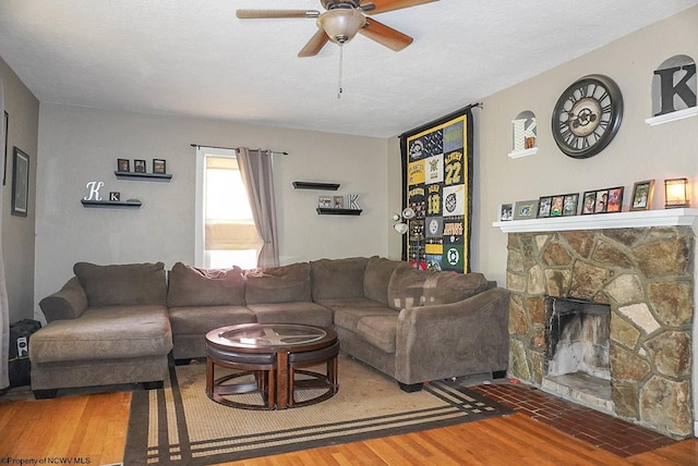 1917 Pleasant Valley Rd, Fairmont, WV 26554 - living area with a ceiling fan, wood finished floors, a fireplace, and a textured ceiling