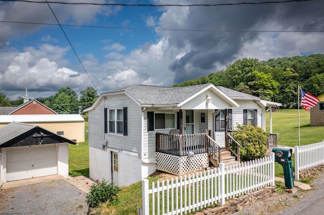 1501 Rose Ln, Fairmont, WV 26554 - view of front facade featuring covered porch, a shingled roof, driveway, and an outdoor structure