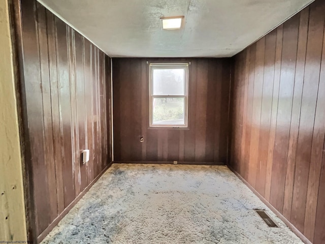 1501 Rose Ln, Fairmont, WV 26554 - carpeted empty room featuring wood walls and baseboards