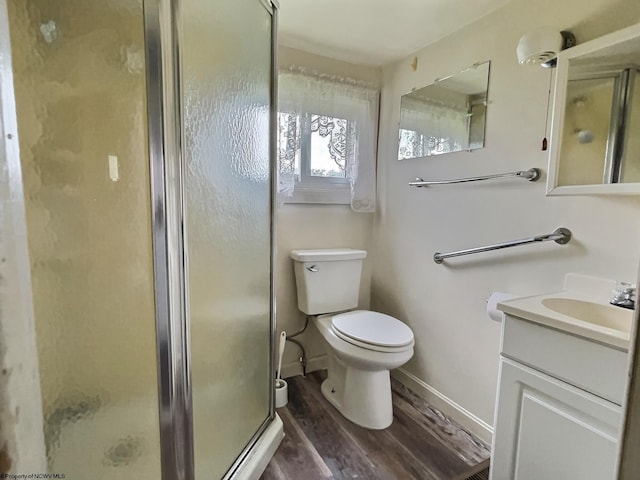 1501 Rose Ln, Fairmont, WV 26554 - bathroom with wood finished floors, vanity, a stall shower, toilet, and baseboards