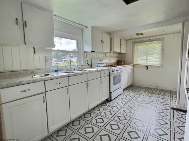 1501 Rose Ln, Fairmont, WV 26554 - kitchen with white gas range, a sink, white cabinetry, and light countertops