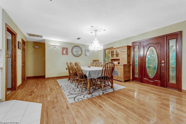 237 Highland Ave, Grafton, WV 26354 - dining space with light wood finished floors, a chandelier, and baseboards