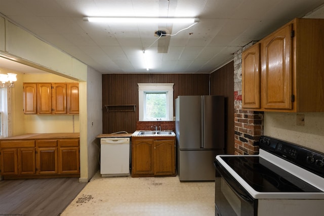 248 Casteel Rd, Terra Alta, WV 26764 - kitchen with range with electric stovetop, freestanding refrigerator, dishwasher, a sink, and brown cabinets