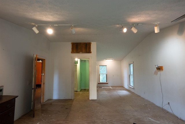 248 Casteel Rd, Terra Alta, WV 26764 - unfurnished room with track lighting, vaulted ceiling, and a textured ceiling
