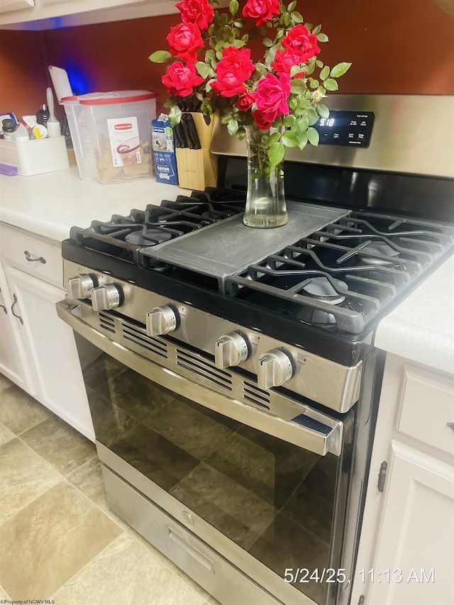 344 Tygart St, Fairmont, WV 26554 - kitchen view of gas stove, white cabinetry, and light countertops