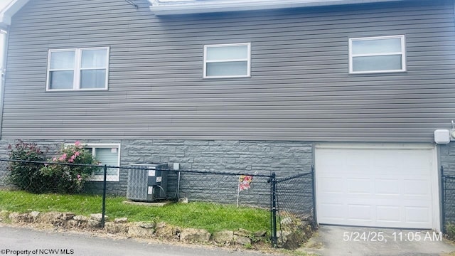 344 Tygart St, Fairmont, WV 26554 - view of home's exterior with a garage, central AC, and stone siding