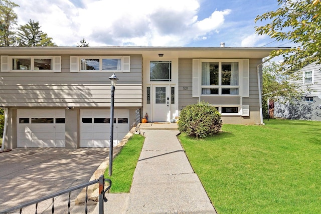 521 Woodhaven Dr, Morgantown, WV 26505 - bi-level home with an attached garage, concrete driveway, and a front lawn