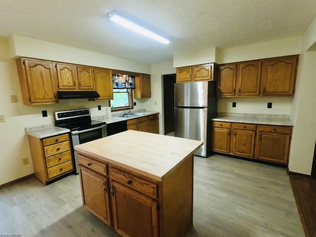183 Camp Mountaineer Rd, Morgantown, WV 26508 - kitchen with appliances with stainless steel finishes, under cabinet range hood, a sink, light wood finished floors, and a textured ceiling