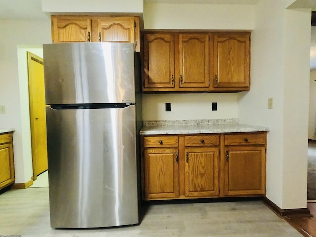 183 Camp Mountaineer Rd, Morgantown, WV 26508 - kitchen featuring freestanding refrigerator, brown cabinetry, and light countertops