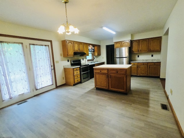 183 Camp Mountaineer Rd, Morgantown, WV 26508 - kitchen with stainless steel appliances, a sink, under cabinet range hood, light wood-style flooring, and a chandelier