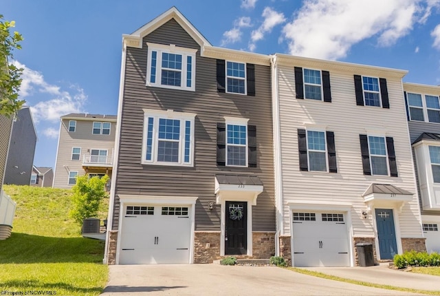 233 Stonehurst Dr, Morgantown, WV 26501 - townhome / multi-family property featuring concrete driveway, an attached garage, stone siding, and central AC unit