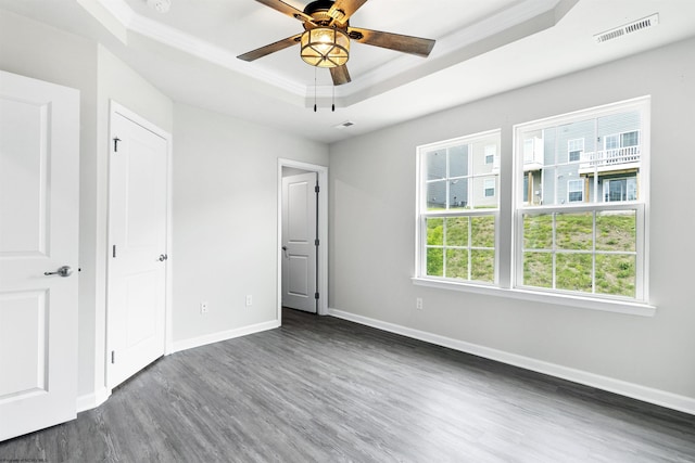 233 Stonehurst Dr, Morgantown, WV 26501 - unfurnished bedroom with a tray ceiling, dark wood-type flooring, baseboards, and a ceiling fan
