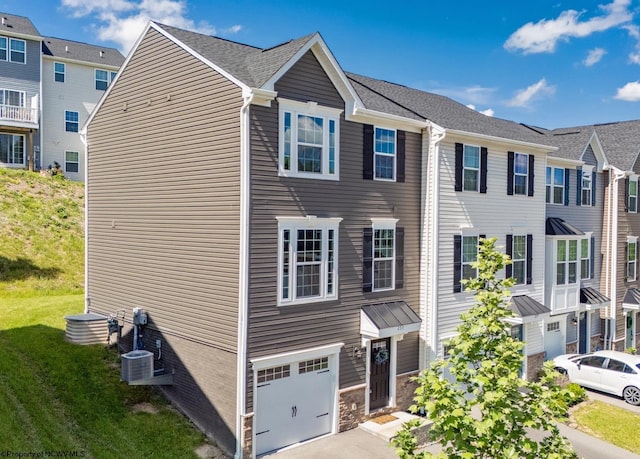233 Stonehurst Dr, Morgantown, WV 26501 - view of property with an attached garage, cooling unit, and asphalt driveway