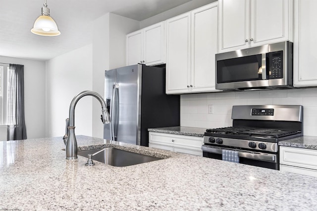 233 Stonehurst Dr, Morgantown, WV 26501 - kitchen featuring appliances with stainless steel finishes, a sink, backsplash, and white cabinets