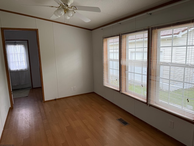 227 Wamsley Way, Valley Bend, WV 26293 - empty room featuring light wood finished floors, ceiling fan, plenty of natural light, and ornamental molding