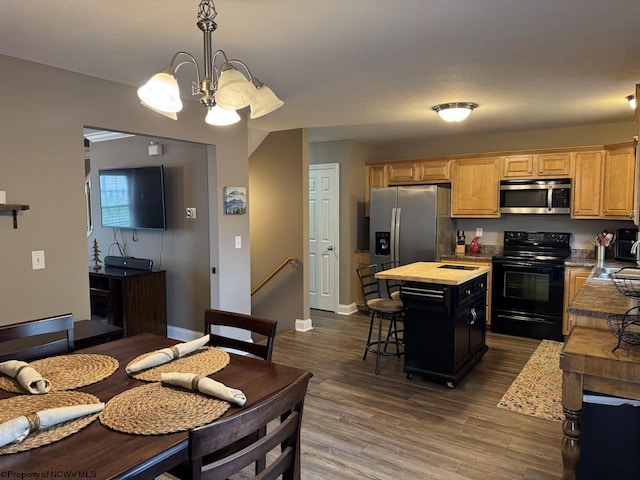 203 Tarbert Ct, Morgantown, WV 26508 - kitchen featuring stainless steel appliances, a chandelier, a kitchen island, dark wood-style floors, and a breakfast bar
