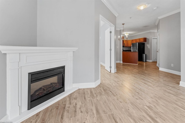 1318 Suncrest Vlg, Morgantown, WV 26505 - unfurnished living room with a chandelier, ornamental molding, light wood-style flooring, and baseboards