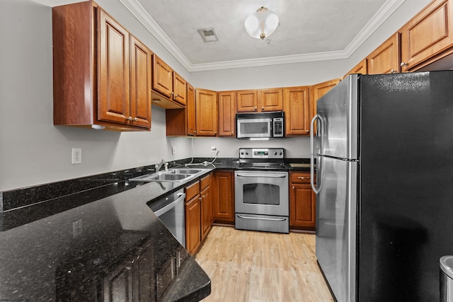 1318 Suncrest Vlg, Morgantown, WV 26505 - kitchen featuring stainless steel appliances, light wood finished floors, a sink, ornamental molding, and brown cabinets