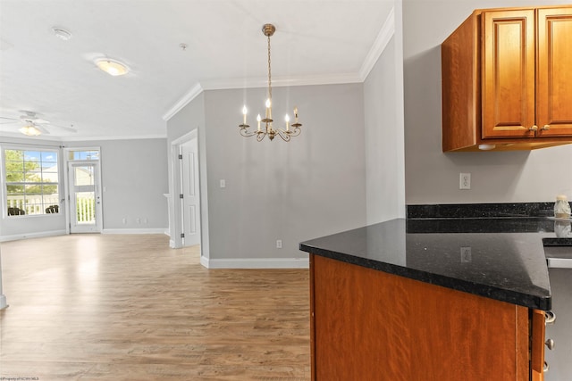 1318 Suncrest Vlg, Morgantown, WV 26505 - kitchen featuring crown molding, light wood finished floors, brown cabinetry, a ceiling fan, and baseboards