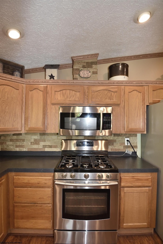 267 W Fork St, Clarksburg, WV 26301 - kitchen featuring appliances with stainless steel finishes, dark countertops, tasteful backsplash, a textured ceiling, and crown molding